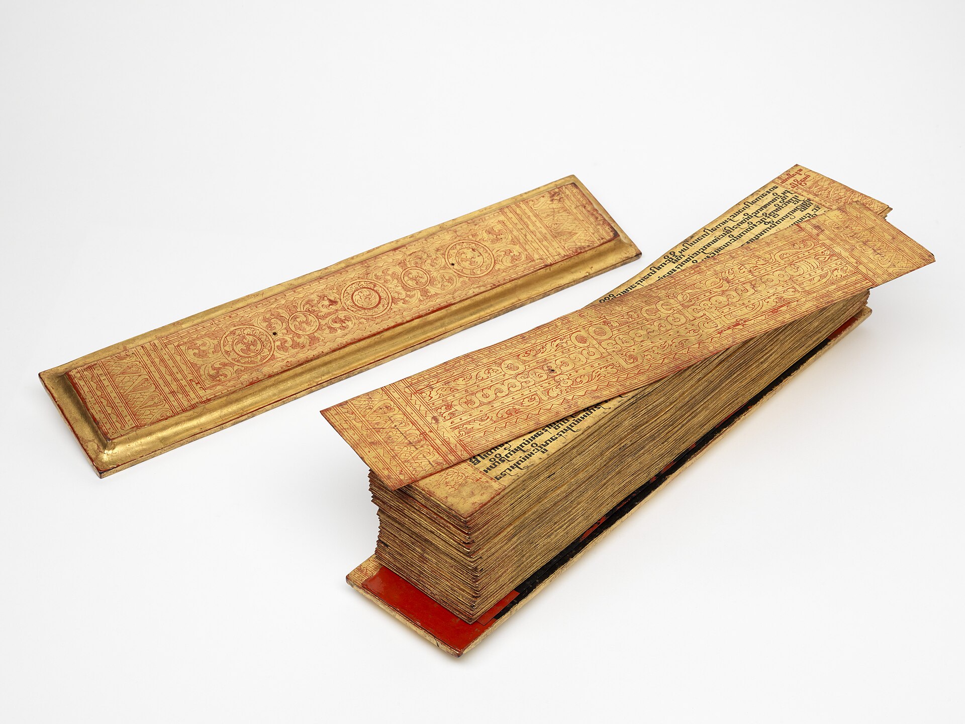 A gilded Burmese-Pali palm-leaf manuscript with lacquer covers